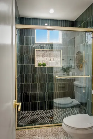 a bathroom with a glass shower door