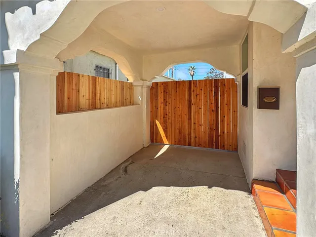 a view of a bedroom with wooden floor and a window