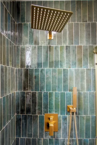 a white vase with flowers sitting on a sink