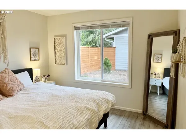 a bedroom with a bed and a large window
