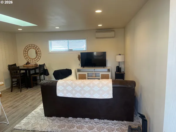 a living room with stainless steel appliances kitchen island granite countertop furniture and a large window