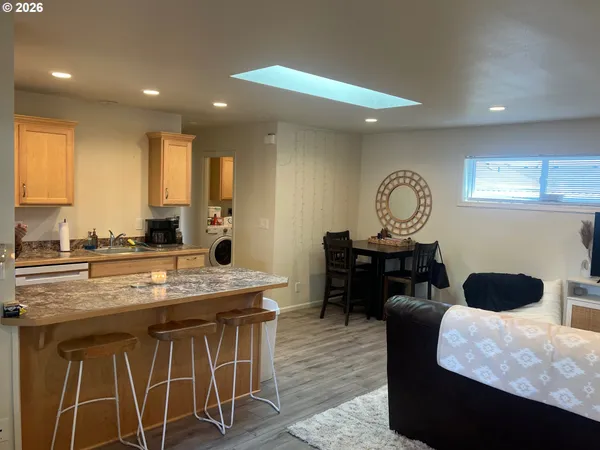 a kitchen with stainless steel appliances granite countertop a stove a refrigerator and a microwave
