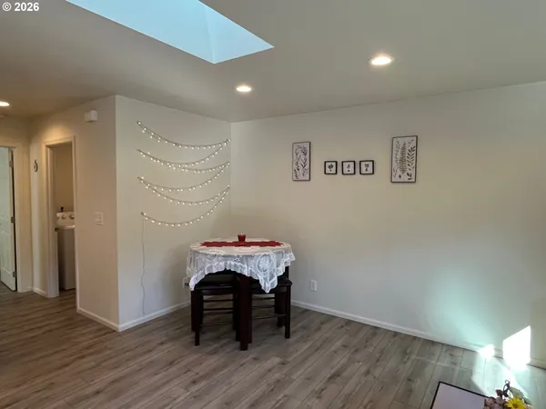 a kitchen with stainless steel appliances granite countertop a sink a stove and wooden floors