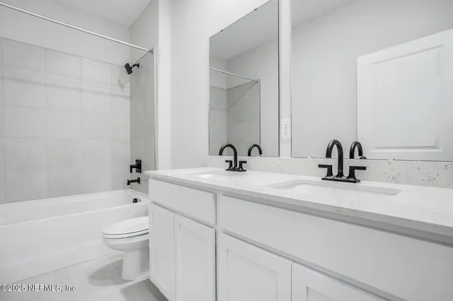 a bathroom with a sink a toilet and a bathtub