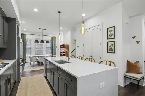a kitchen with a sink a counter top space and stainless steel appliances