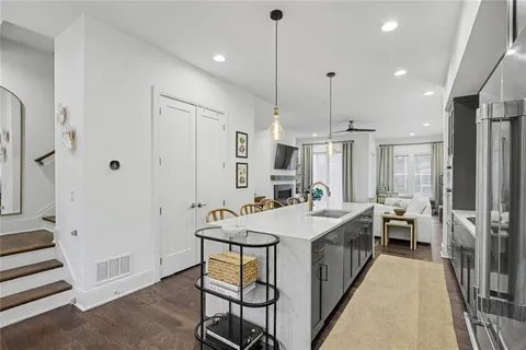 a large kitchen with a lot of counter space and a chandelier