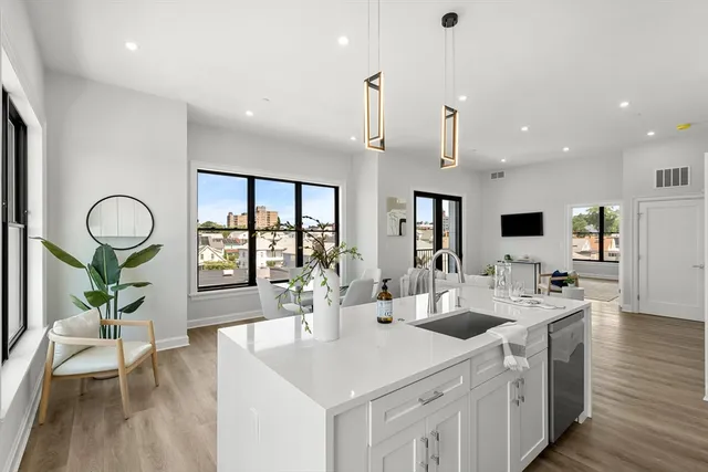 a kitchen that has a sink a stove and a refrigerator