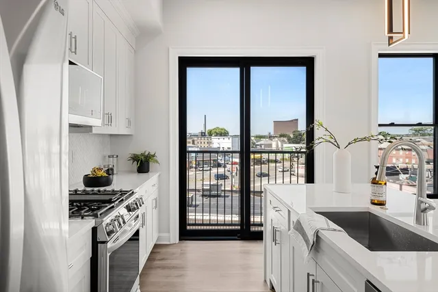 a very nice looking living room with a large window and wooden floor