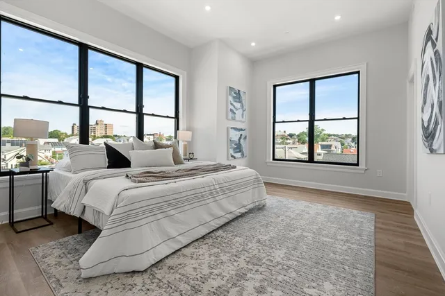 a bed room with a bed and a large window