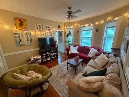 a living room with furniture and a flat screen tv