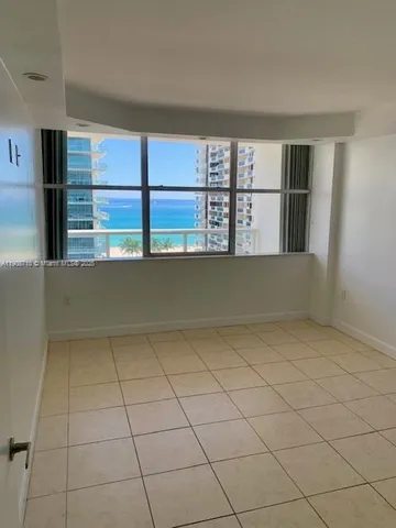 a view of a livingroom with an empty space and a window