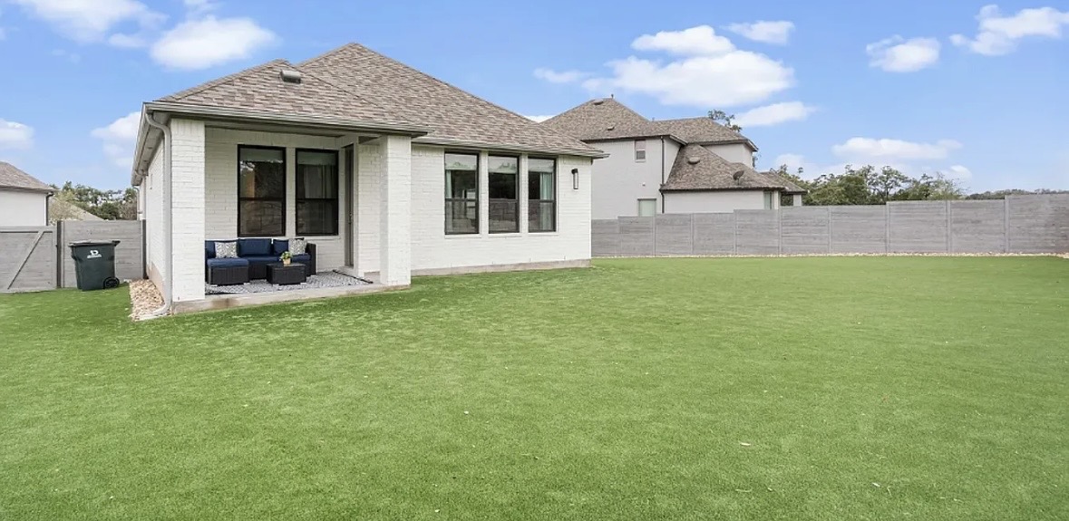109 Arrowhead Mound Road Georgetown, TX 78628 - Photo 8 of 27 An inviting covered patio opens to a sprawling lawn, perfect for outdoor relaxation and entertainment.