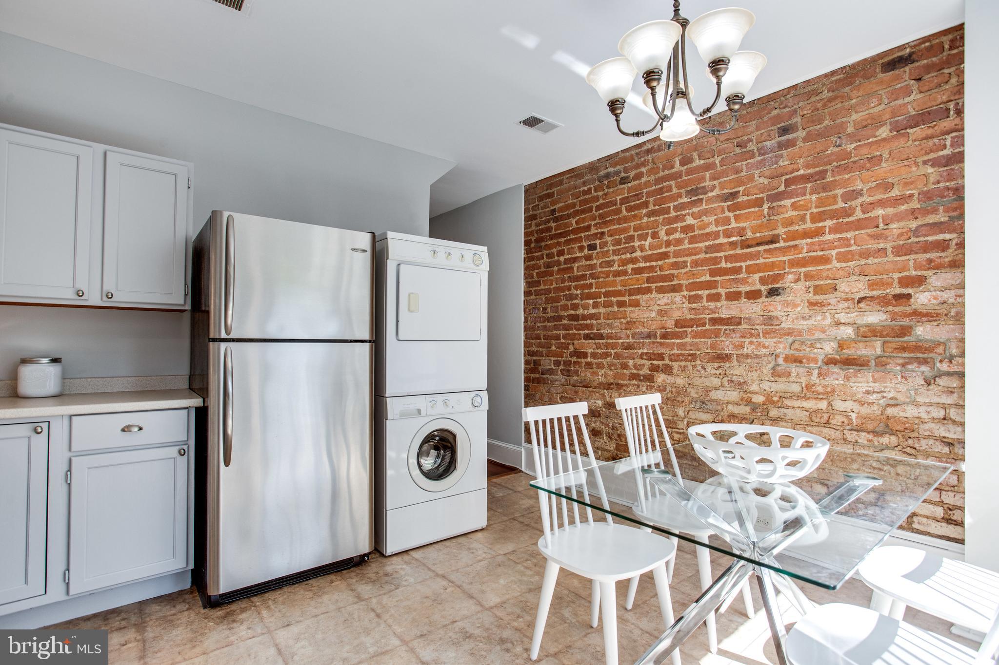241 Warren Street Northeast Washington, DC 20002 - Photo 11 of 43 Washer and dryer with a view, and exposed brick