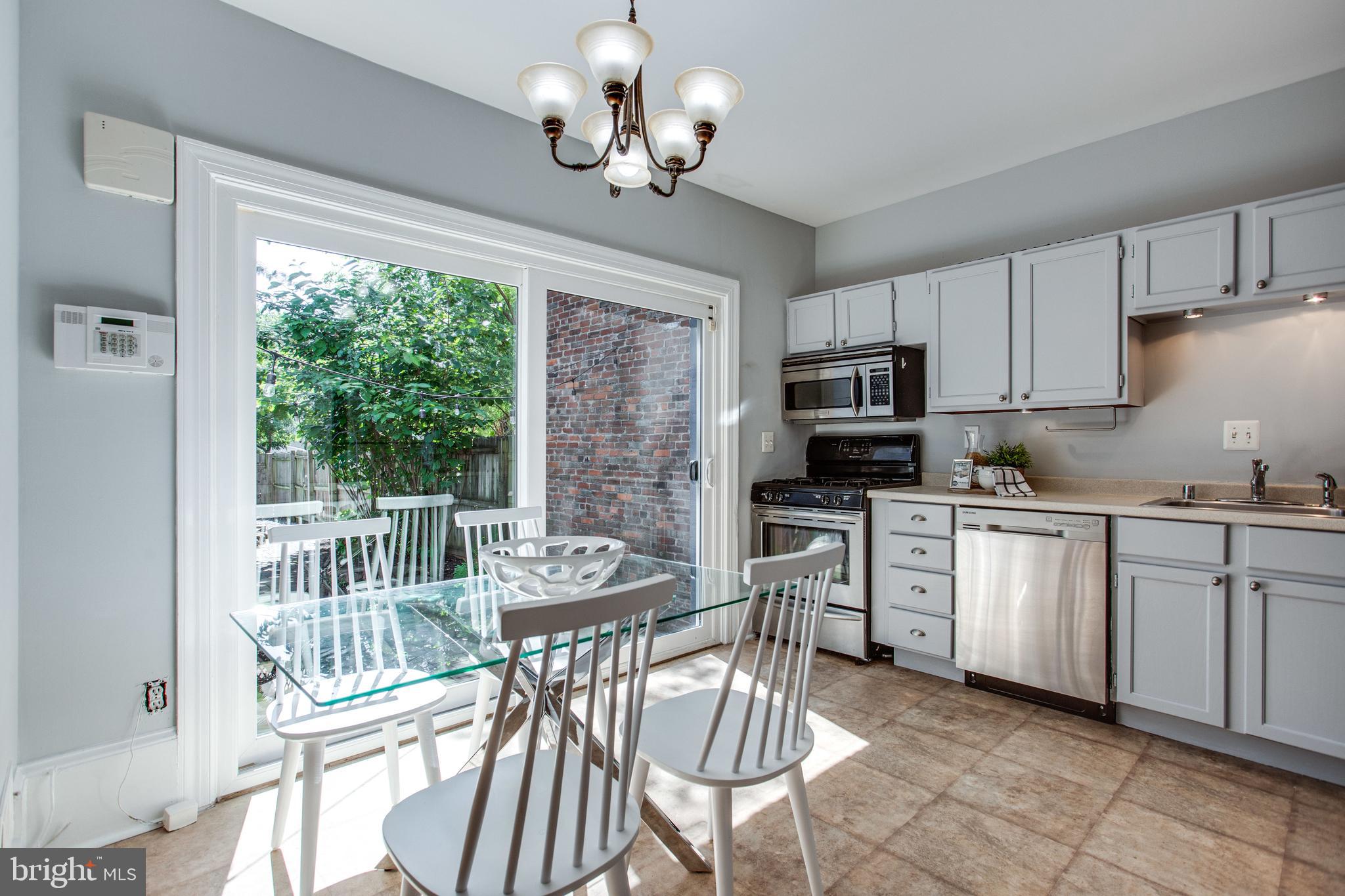 241 Warren Street Northeast Washington, DC 20002 - Photo 8 of 43 Sliding glass doors open to patio w/deep backyard