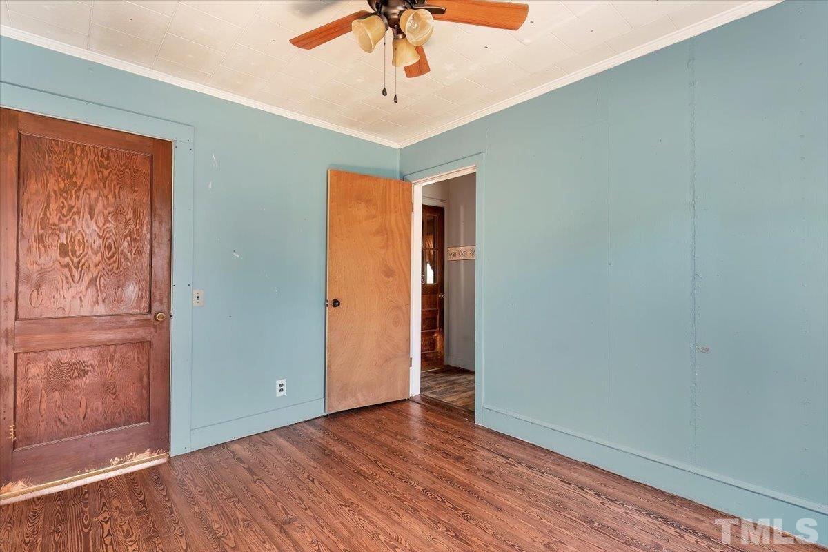 1899 Jason Road Seagrove, NC 27341 - Photo 18 of 51 an empty room with wooden floor fan and windows
