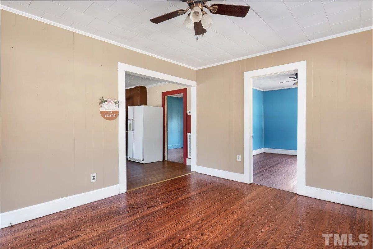 1899 Jason Road Seagrove, NC 27341 - Photo 8 of 51 an empty room with wooden floor and ceiling fan