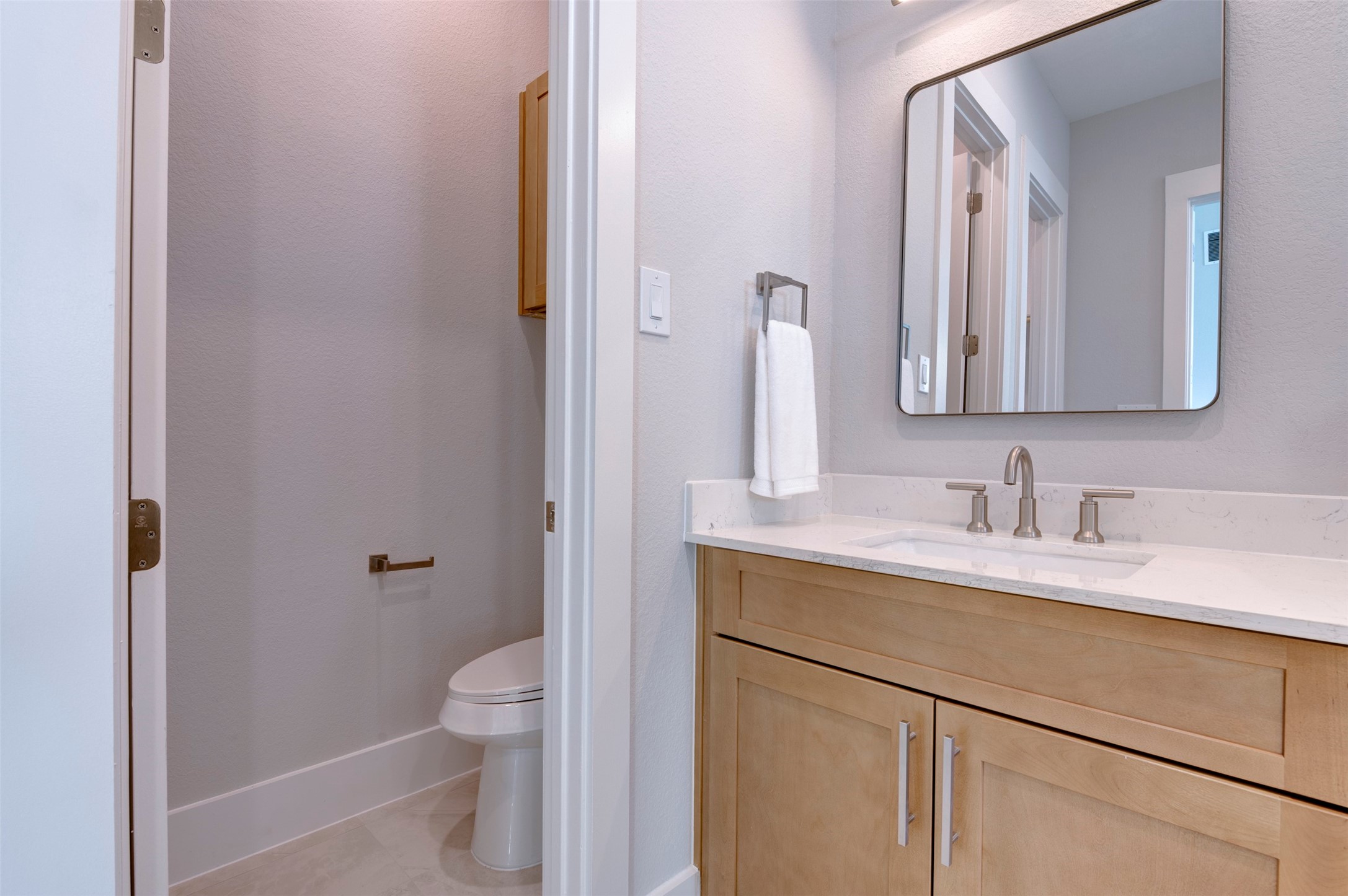 5132 Rosslyn Road Houston, TX 77018 - Photo 31 of 40 a bathroom with a granite countertop sink a toilet and a mirror