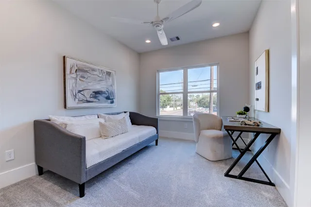 a living room with furniture a window and table