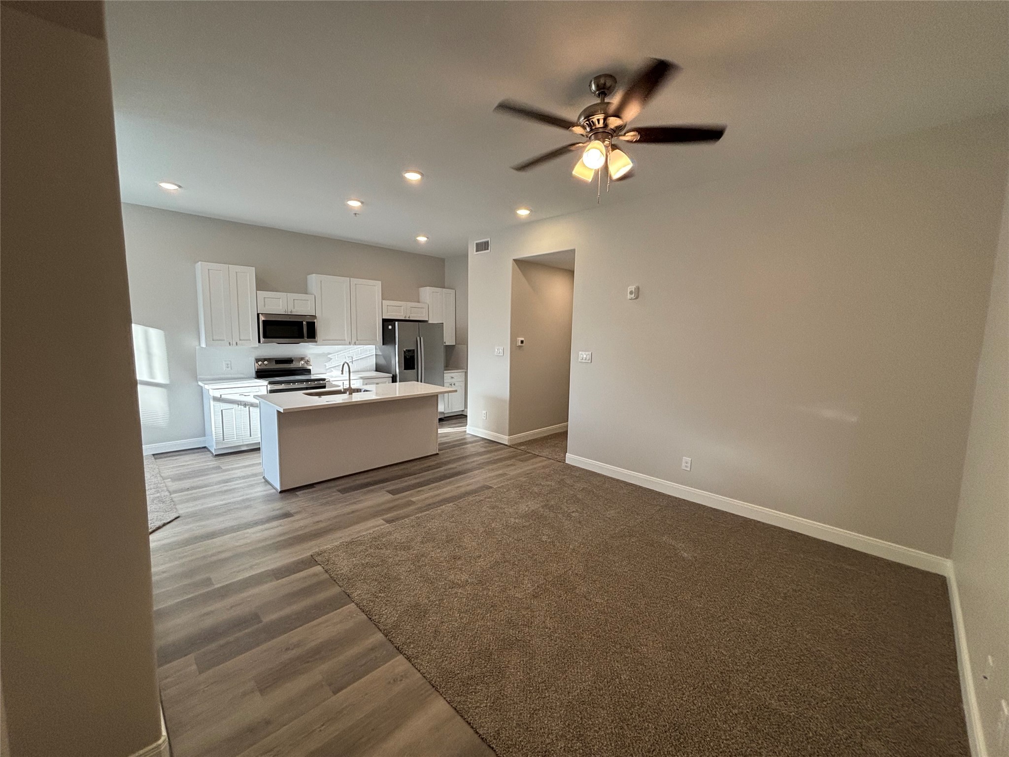 504 Nursery Road, Unit 1108 The Woodlands, TX 77380 - Photo 18 of 25 a view of a kitchen with a sink dishwasher and a refrigerator