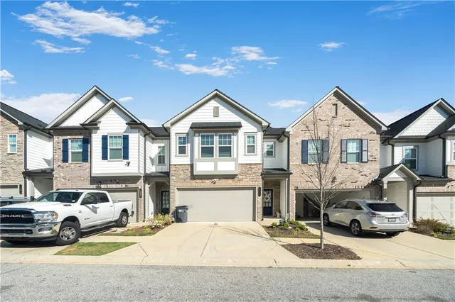 a view of multiple house with a patio and a car parked in front of it