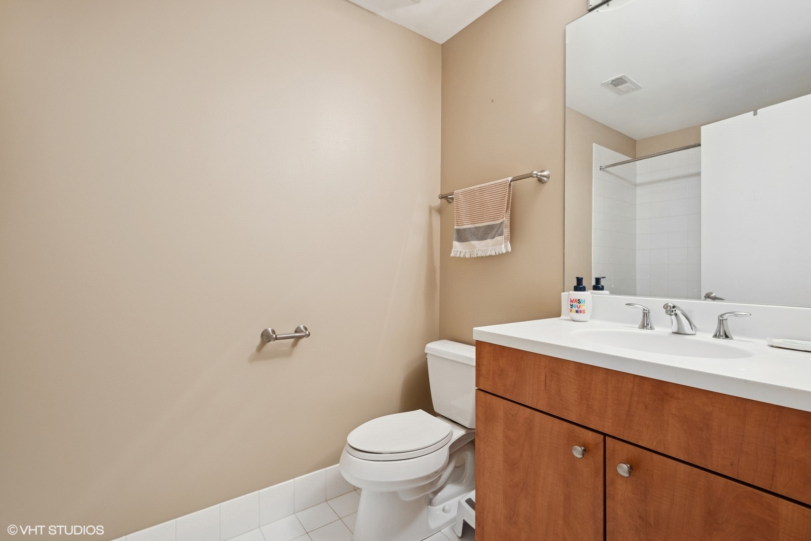 565 West Quincy Street, Unit 609 Chicago, IL 60661 - Photo 11 of 16 a bathroom with a sink a toilet and mirror