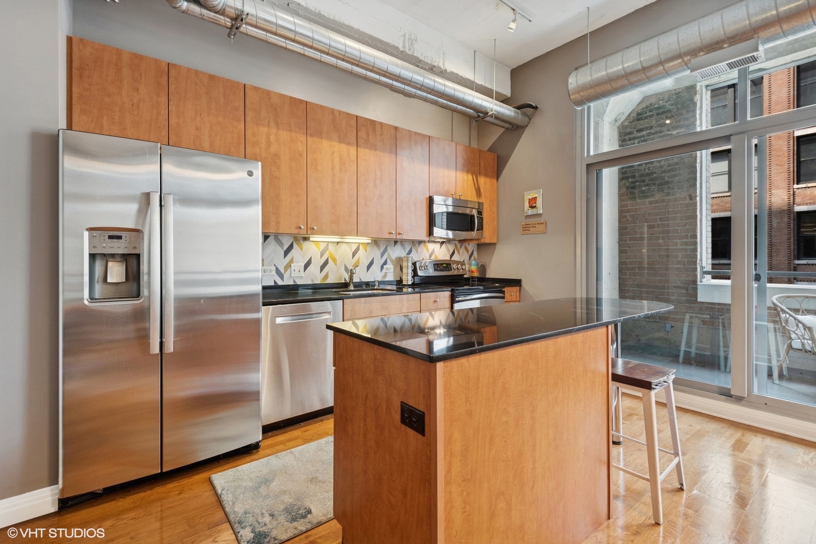 565 West Quincy Street, Unit 609 Chicago, IL 60661 - Photo 6 of 16 a kitchen with granite countertop a refrigerator and a sink