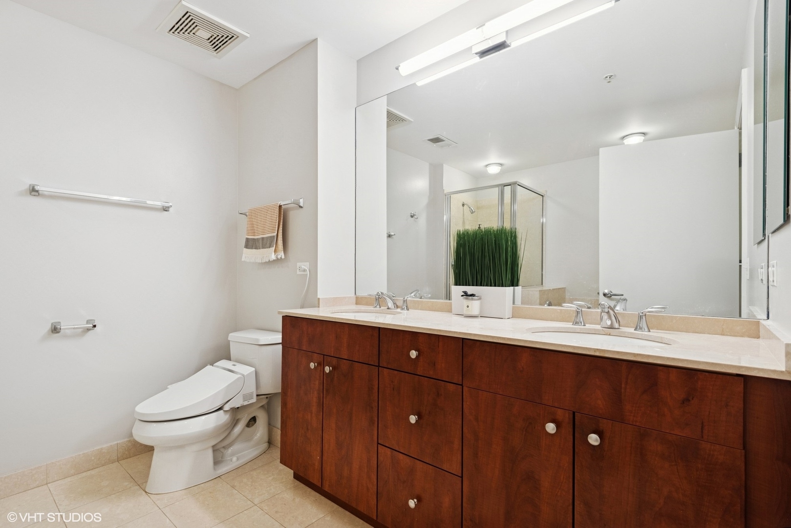 565 West Quincy Street, Unit 609 Chicago, IL 60661 - Photo 9 of 16 a bathroom with a double vanity sink mirror and toilet