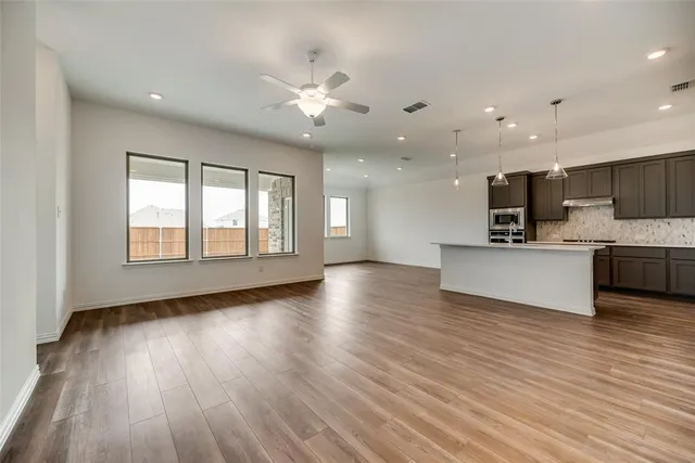 a view of kitchen with sink and wooden floor