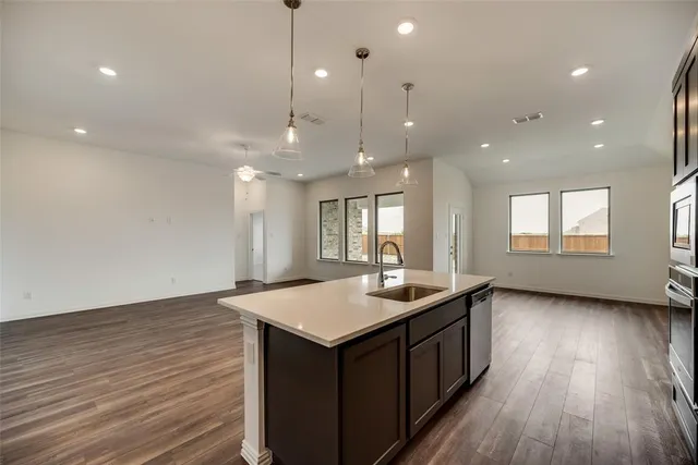 a view of a big house with a big yard and large trees