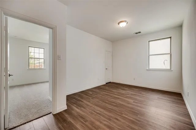 a kitchen with a sink chandelier and wooden floor