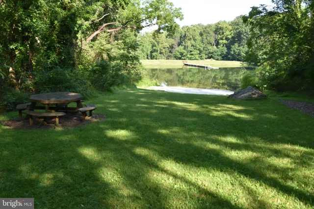 a view of a green field with a lake view