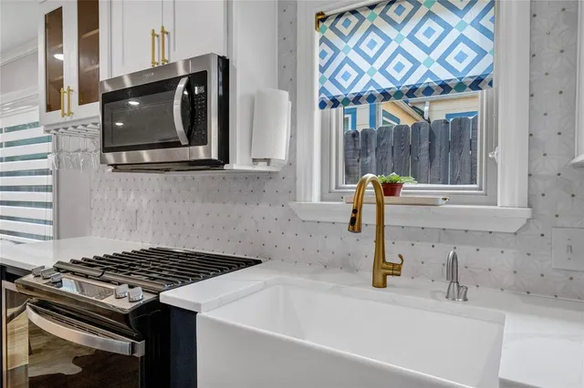 a kitchen with a sink cabinets and wooden floor