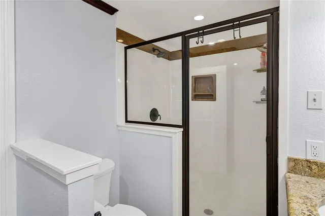a bathroom with a double vanity sink mirror and shower