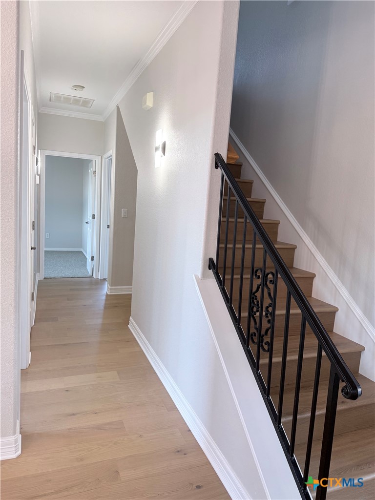 1084 Frederick Lane Temple, TX 76502 - Photo 12 of 40 a view of a hallway with wooden floor and staircase