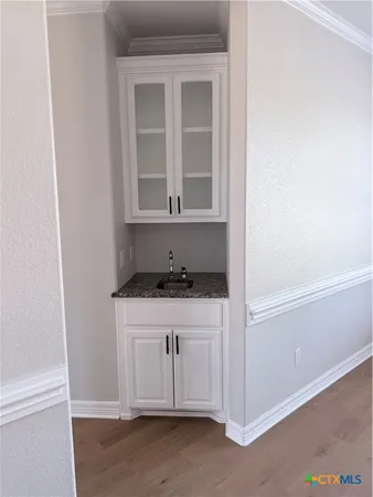 a kitchen with a sink cabinets and a window