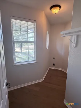 a view of a room with window and hardwood floor