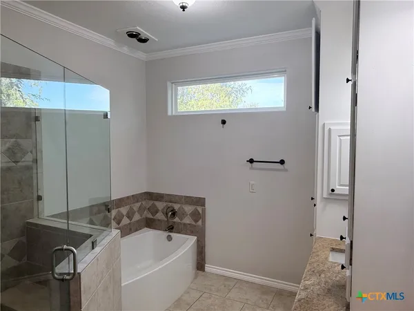 a bathroom with a bathtub and shower