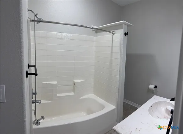 a bathroom with a bathtub and a shower