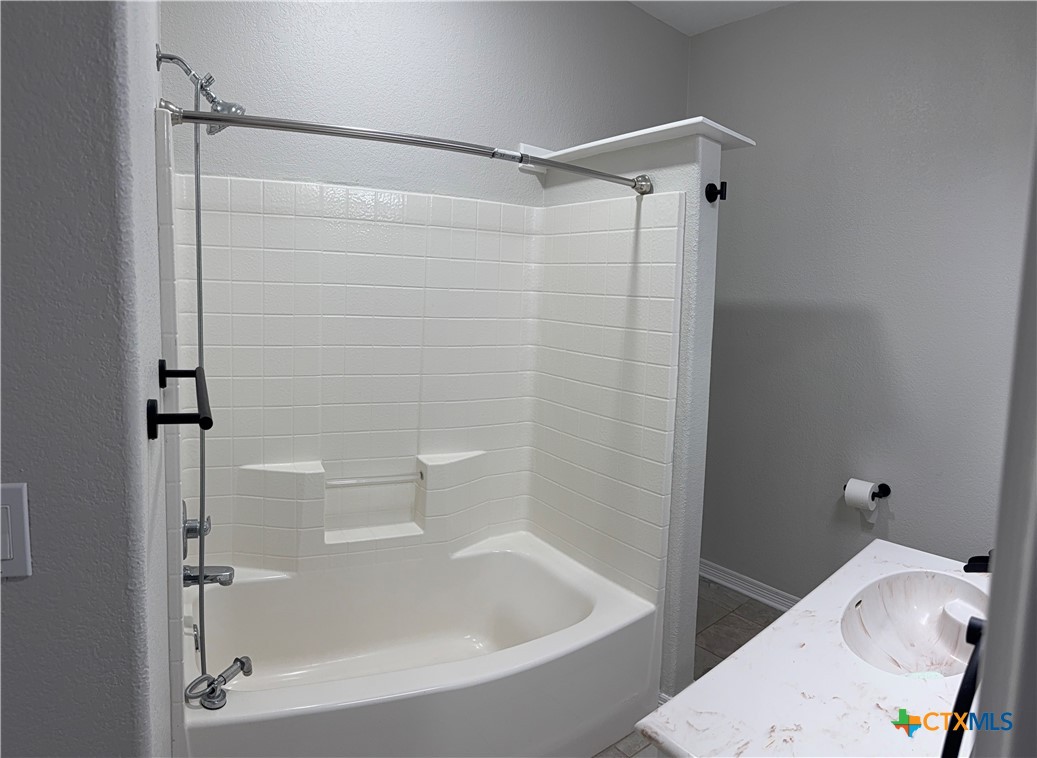 1084 Frederick Lane Temple, TX 76502 - Photo 28 of 40 a bathroom with a bathtub and a shower