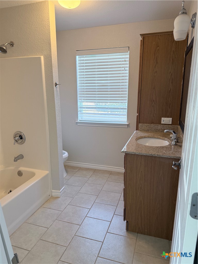 1084 Frederick Lane Temple, TX 76502 - Photo 31 of 40 a bathroom with a bathtub sink and mirror