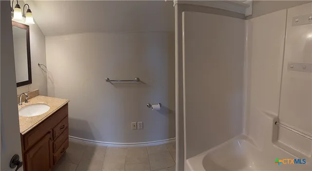 a bathroom with a sink and shower