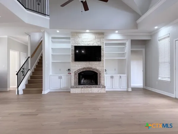 a view of a livingroom with an empty space and a fireplace
