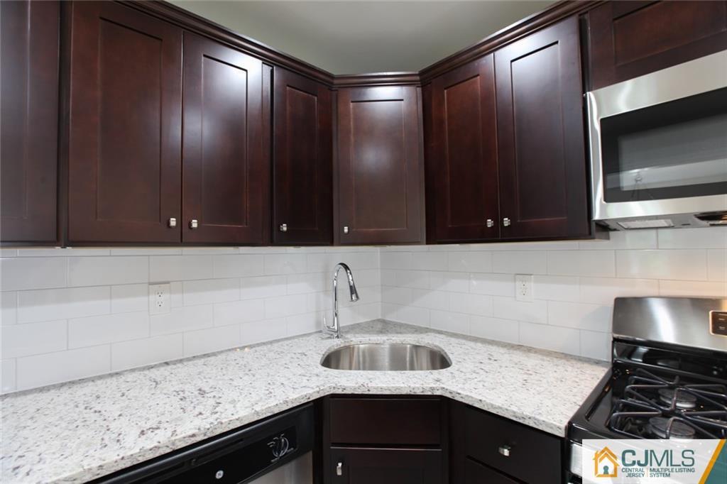 3008 Hana Road Edison, NJ 08817 - Photo 4 of 24 a kitchen with a sink and cabinets