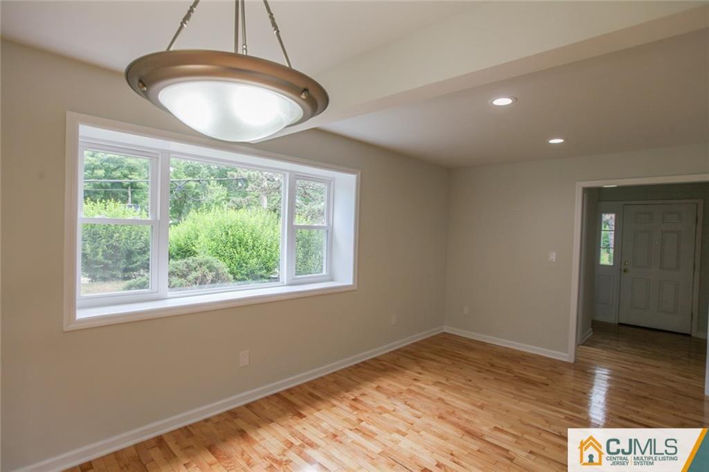 3008 Hana Road Edison, NJ 08817 - Photo 8 of 24 a view of an empty room with wooden floor and a window
