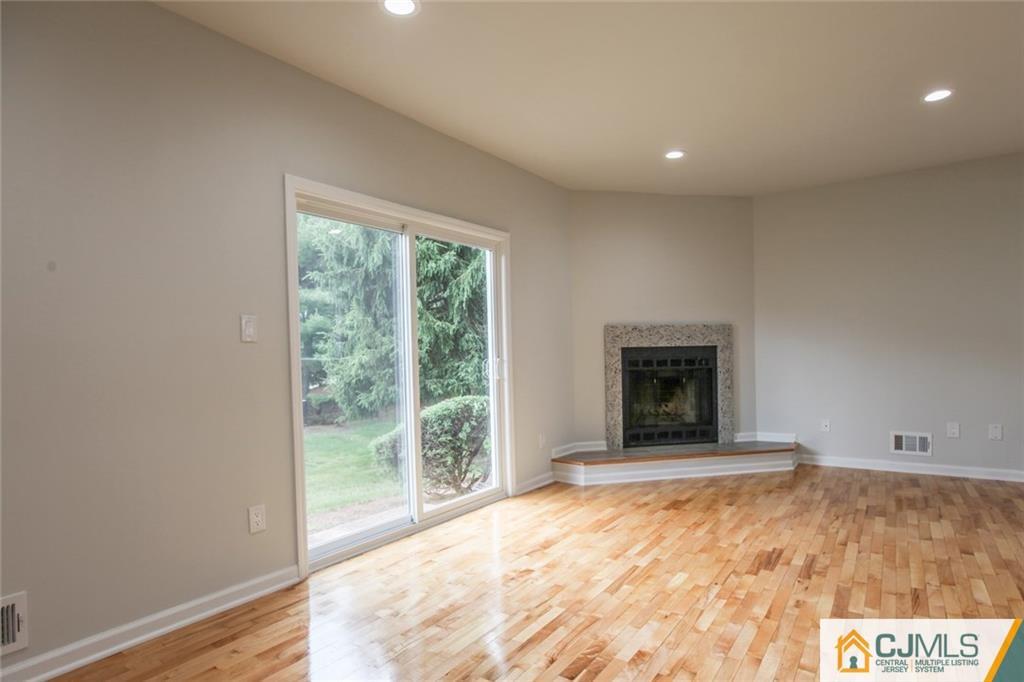 3008 Hana Road Edison, NJ 08817 - Photo 9 of 24 a view of an empty room with a window and a fireplace
