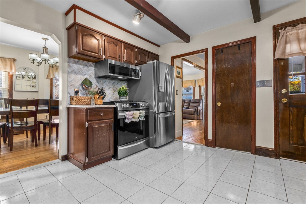 65 Poplar Street Gloucester, MA 01930 - Photo 11 of 23 a kitchen with stainless steel appliances granite countertop a refrigerator and a sink
