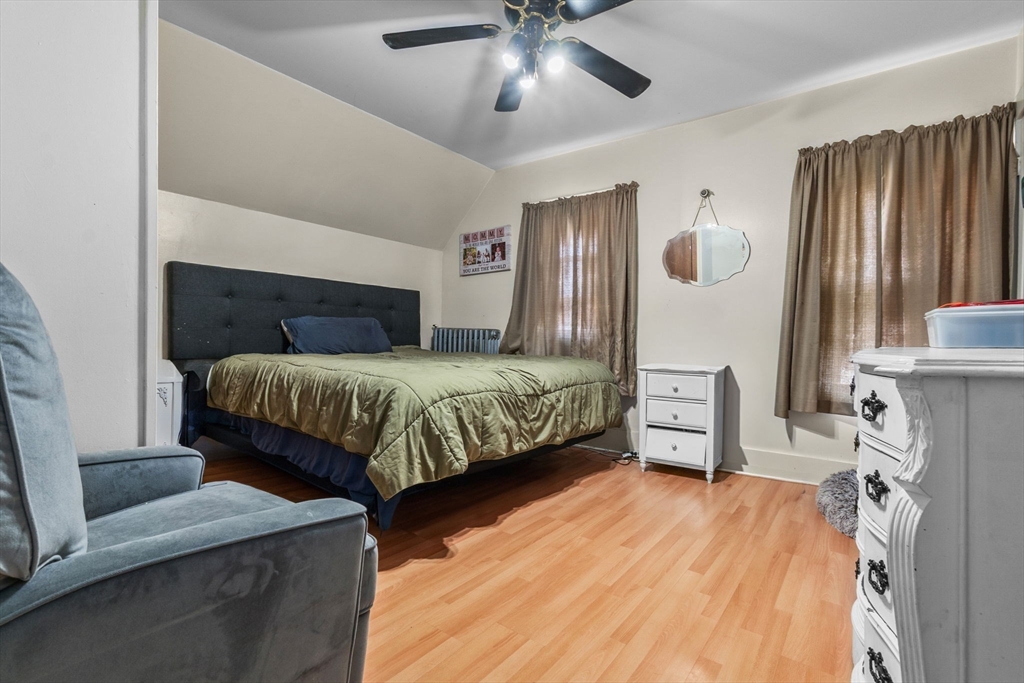 65 Poplar Street Gloucester, MA 01930 - Photo 16 of 23 a bedroom with a bed and wooden floor