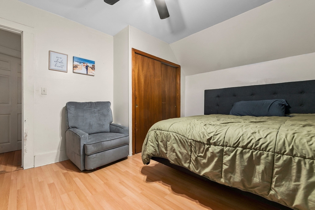 65 Poplar Street Gloucester, MA 01930 - Photo 17 of 23 a bedroom with a bed couch and window