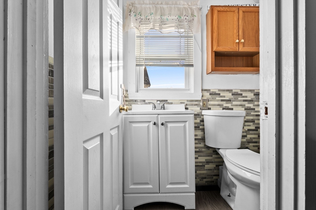 65 Poplar Street Gloucester, MA 01930 - Photo 19 of 23 a bathroom with a sink a toilet and a mirror