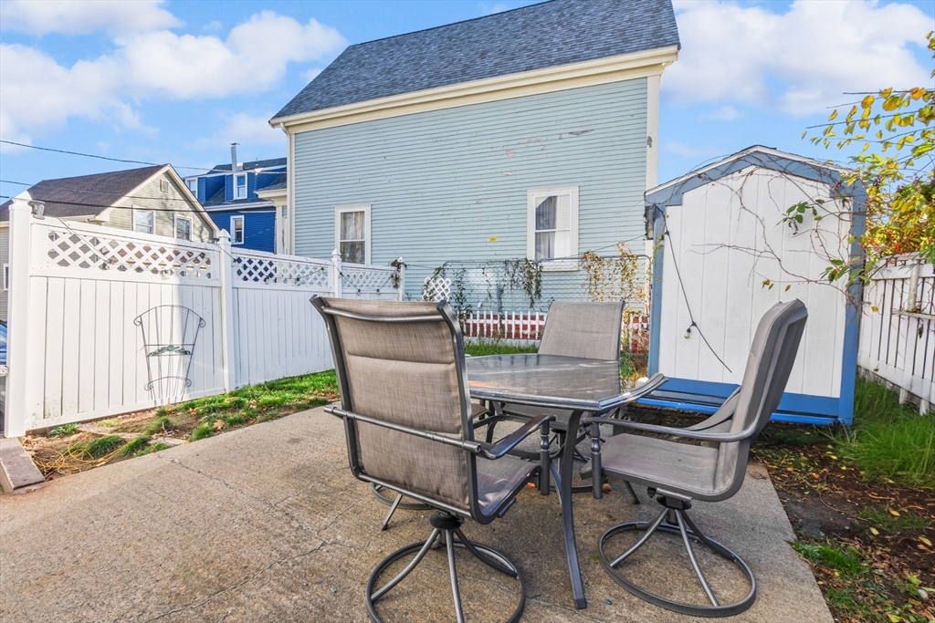65 Poplar Street Gloucester, MA 01930 - Photo 21 of 23 a view of a patio with table and chairs with wooden floor and fence